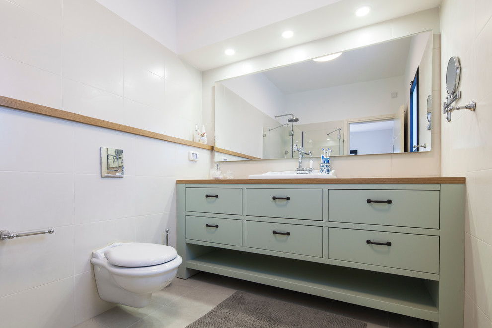 Inredning av ett modernt stort en-suite badrum, med möbel-liknande, blå skåp, träbänkskiva, en hörndusch, en vägghängd toalettstol, beige kakel, keramikplattor, vita väggar och klinkergolv i keramik