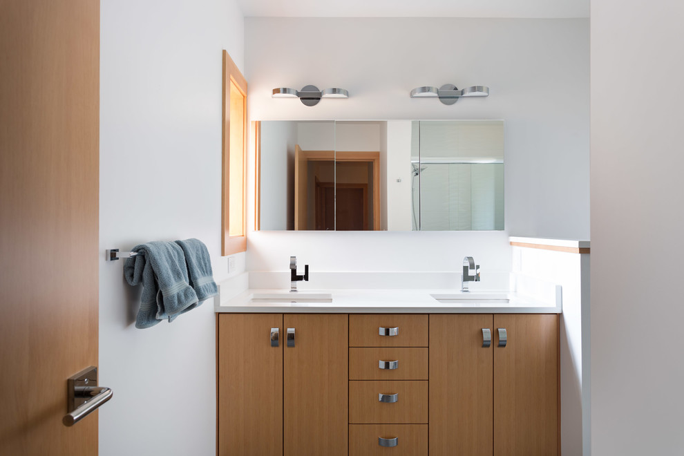 This is an example of a modern ensuite bathroom in Seattle with flat-panel cabinets, a corner bath, a built-in shower, white walls, ceramic flooring, a submerged sink, engineered stone worktops, grey floors and a hinged door.