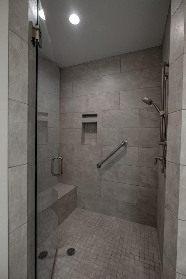 Стильный дизайн: главная ванная комната с серой плиткой, серыми стенами, серым полом и душем с распашными дверями - последний тренд