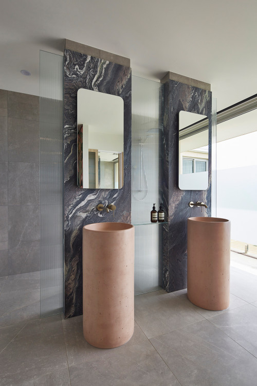 Pretty in Pink: Freestanding Sinks and Vertical Marble Slabs Steal the Show in This Bathroom
