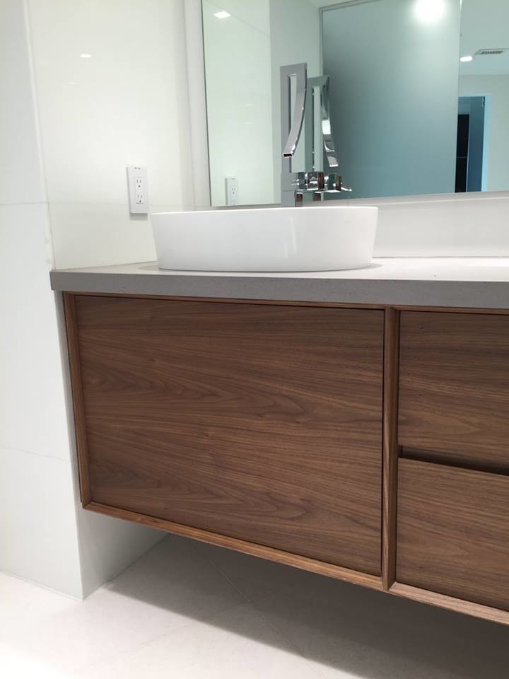 Example of a mid-sized minimalist master gray tile and stone slab white floor bathroom design in Miami with flat-panel cabinets, medium tone wood cabinets, white walls, a vessel sink and concrete countertops
