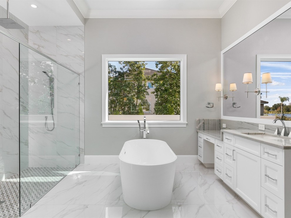 Large transitional master white tile and marble tile marble floor and white floor bathroom photo in Orlando with recessed-panel cabinets, white cabinets, a two-piece toilet, gray walls, an undermount sink, quartzite countertops and gray countertops
