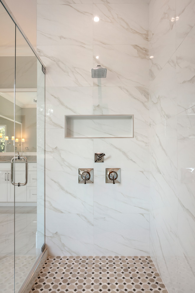 This is an example of a large traditional ensuite bathroom in Orlando with recessed-panel cabinets, white cabinets, a freestanding bath, an alcove shower, a two-piece toilet, white tiles, marble tiles, grey walls, marble flooring, a submerged sink, quartz worktops, white floors, a shower curtain and grey worktops.
