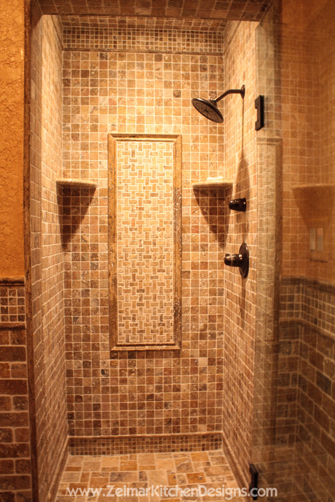 Doorless shower - large traditional master beige tile and stone tile travertine floor doorless shower idea in Orlando with an undermount sink, raised-panel cabinets, distressed cabinets and granite countertops