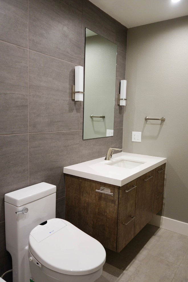 Medium sized contemporary shower room bathroom in San Francisco with flat-panel cabinets, brown cabinets, an alcove bath, a shower/bath combination, a two-piece toilet, white tiles, porcelain tiles, brown walls, porcelain flooring, a submerged sink, engineered stone worktops, grey floors, a shower curtain and white worktops.