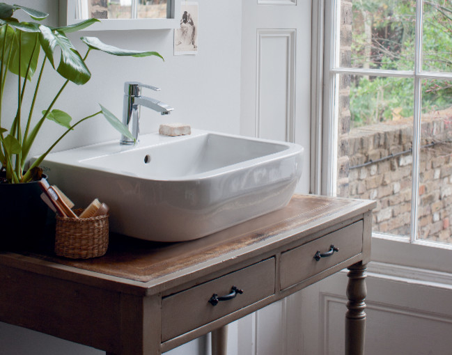 Design ideas for a medium sized contemporary family bathroom in Cambridgeshire with flat-panel cabinets, white cabinets, a built-in bath, a built-in shower, a one-piece toilet, grey tiles, porcelain tiles, grey walls, marble flooring and a pedestal sink.