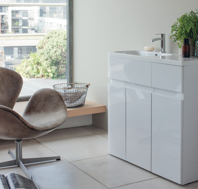 Design ideas for a medium sized contemporary family bathroom in Cambridgeshire with flat-panel cabinets, white cabinets, a built-in bath, a built-in shower, a one-piece toilet, grey tiles, porcelain tiles, grey walls, marble flooring and a pedestal sink.