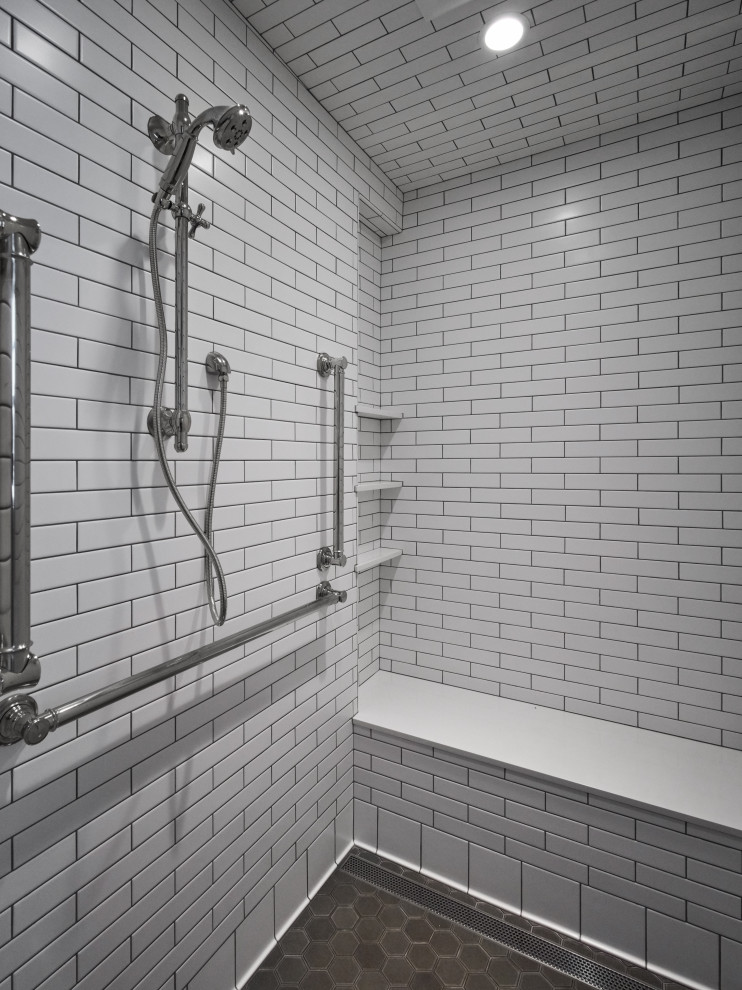This is an example of a medium sized classic ensuite bathroom in Portland with recessed-panel cabinets, white cabinets, an alcove shower, a one-piece toilet, white tiles, metro tiles, blue walls, ceramic flooring, a submerged sink, engineered stone worktops, grey floors, a hinged door, black worktops, a single sink and a built in vanity unit.
