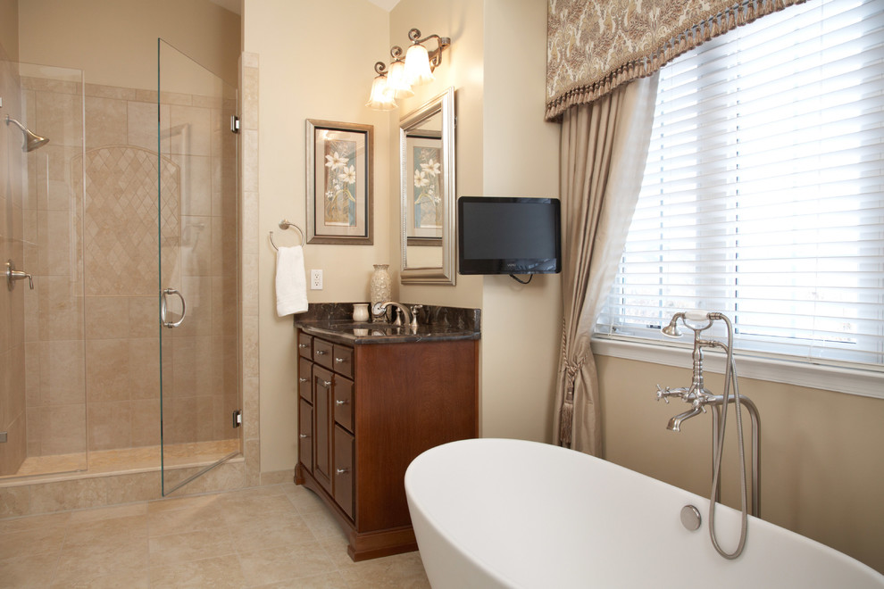 Mid-sized transitional master beige tile and porcelain tile porcelain tile bathroom photo in DC Metro with raised-panel cabinets, medium tone wood cabinets, marble countertops, beige walls, a two-piece toilet and an undermount sink