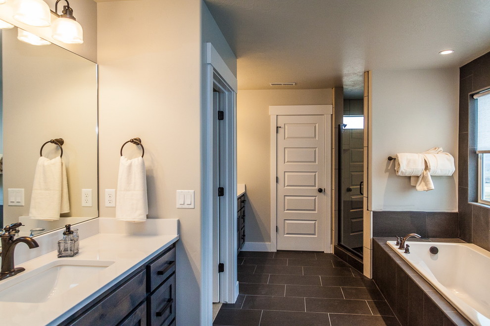 Large ensuite bathroom in Salt Lake City with medium wood cabinets, a one-piece toilet and beige walls.