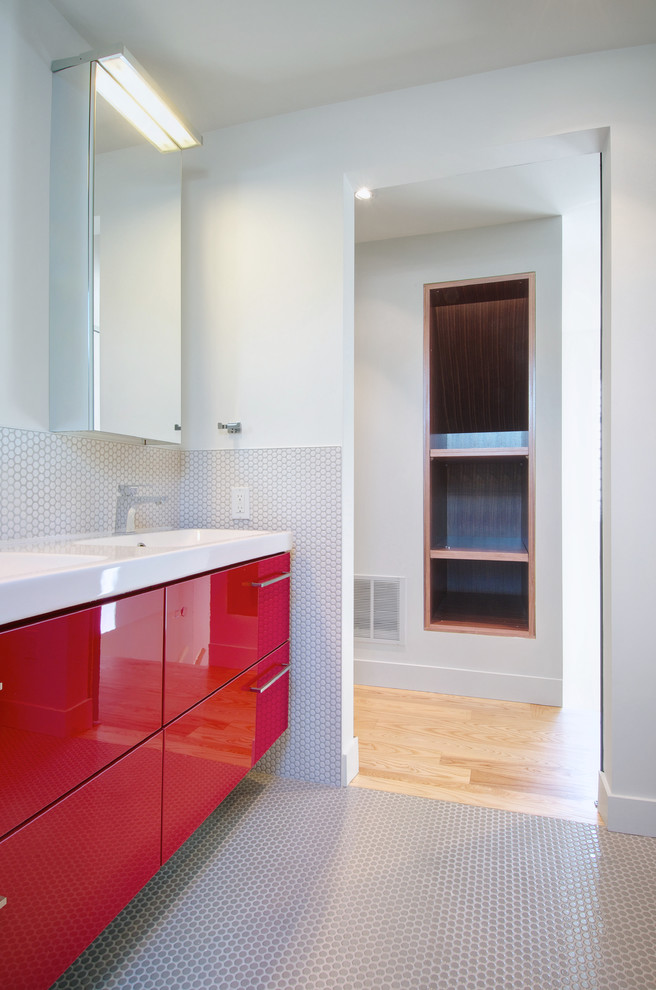 Exemple d'une salle de bain tendance de taille moyenne avec un placard à porte plane, des portes de placard rouges, un carrelage gris, mosaïque, un mur blanc, un sol en carrelage de terre cuite, un lavabo encastré, un sol gris et un plan de toilette blanc.