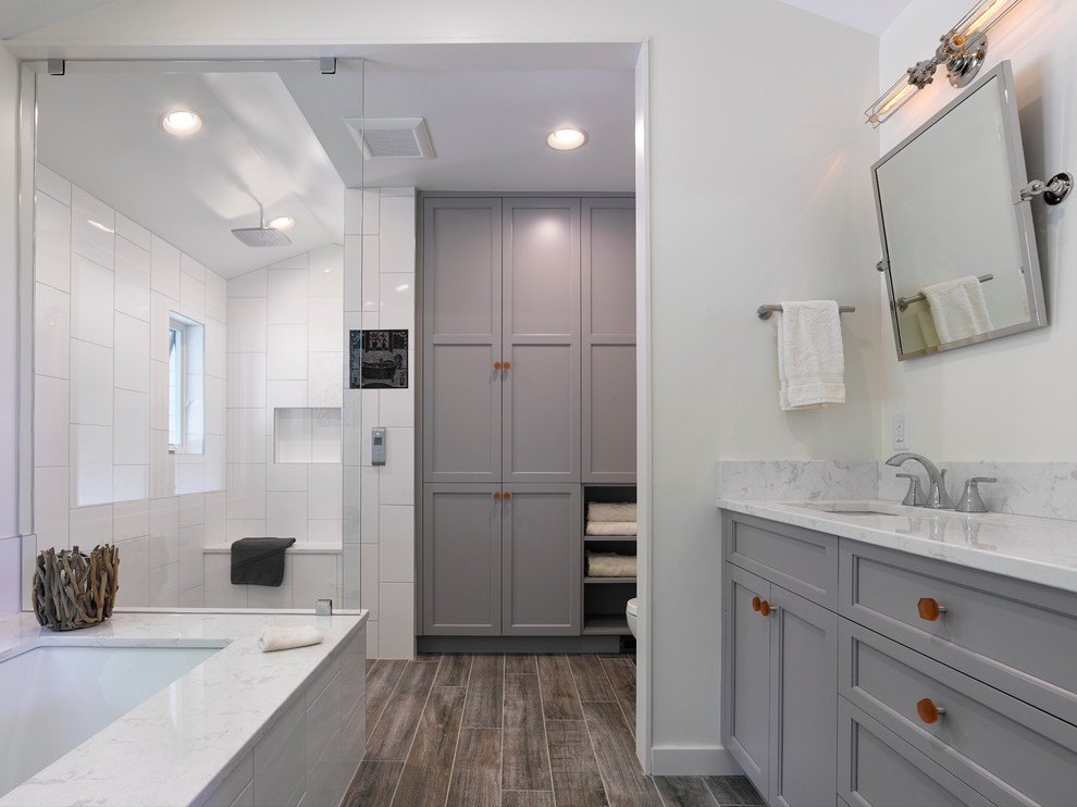 Doorless shower - mid-sized coastal master white tile and porcelain tile ceramic tile doorless shower idea in Baltimore with an undermount sink, recessed-panel cabinets, gray cabinets, quartz countertops, an undermount tub, a two-piece toilet and white walls