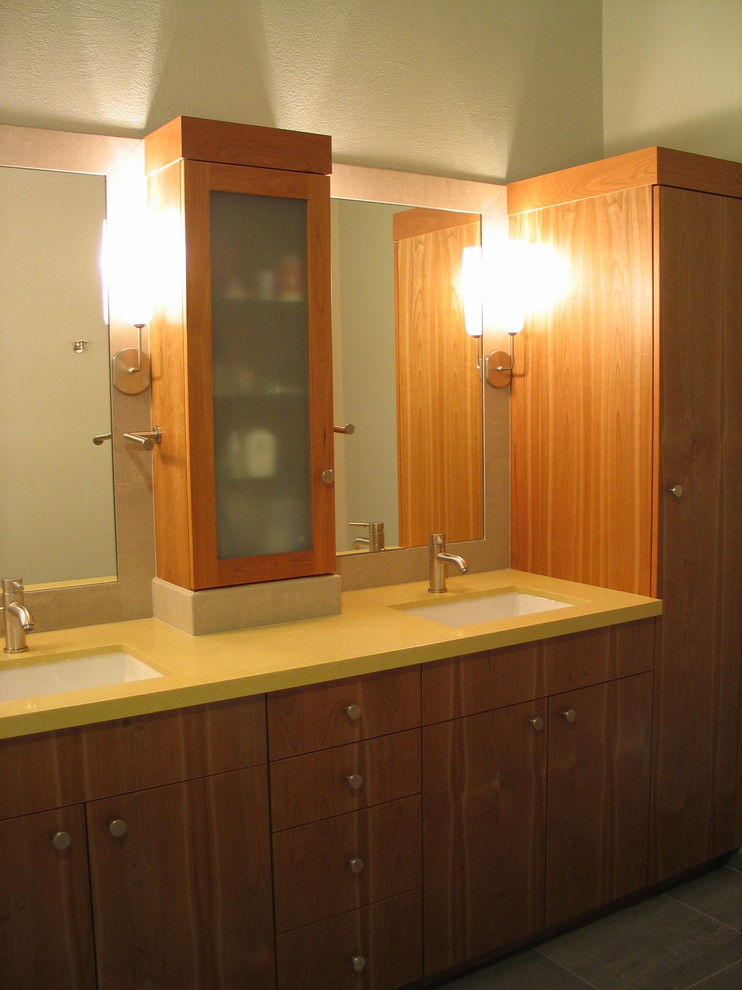 Esempio di una stanza da bagno minimal con ante lisce, ante in legno scuro, top giallo e due lavabi