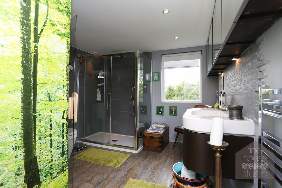 Design ideas for a large bohemian sauna bathroom in London with an integrated sink, freestanding cabinets, dark wood cabinets, a wall mounted toilet, grey tiles, stone tiles, grey walls and medium hardwood flooring.