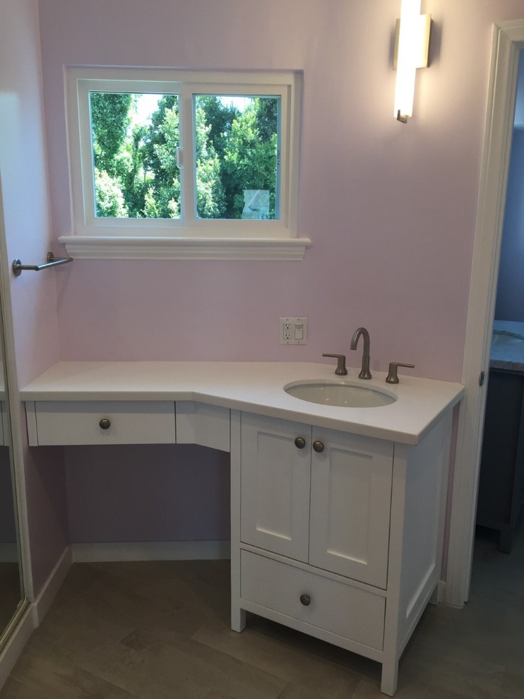 Photo of a large contemporary ensuite bathroom in Los Angeles with grey cabinets, a freestanding bath, a corner shower, grey tiles, white tiles, a submerged sink, freestanding cabinets, a one-piece toilet, pink walls, grey floors, a hinged door, marble tiles, medium hardwood flooring, quartz worktops and grey worktops.