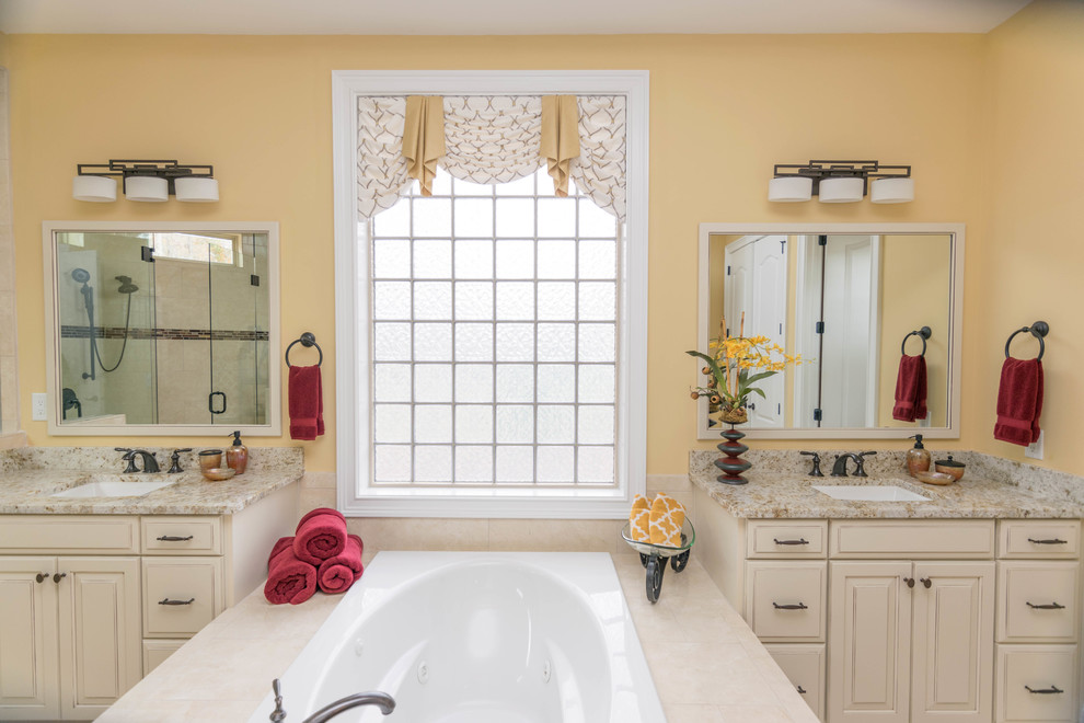 Bathroom - mid-sized transitional master beige tile, brown tile and ceramic tile ceramic tile bathroom idea in Charlotte with raised-panel cabinets, white cabinets, yellow walls, an undermount sink and granite countertops