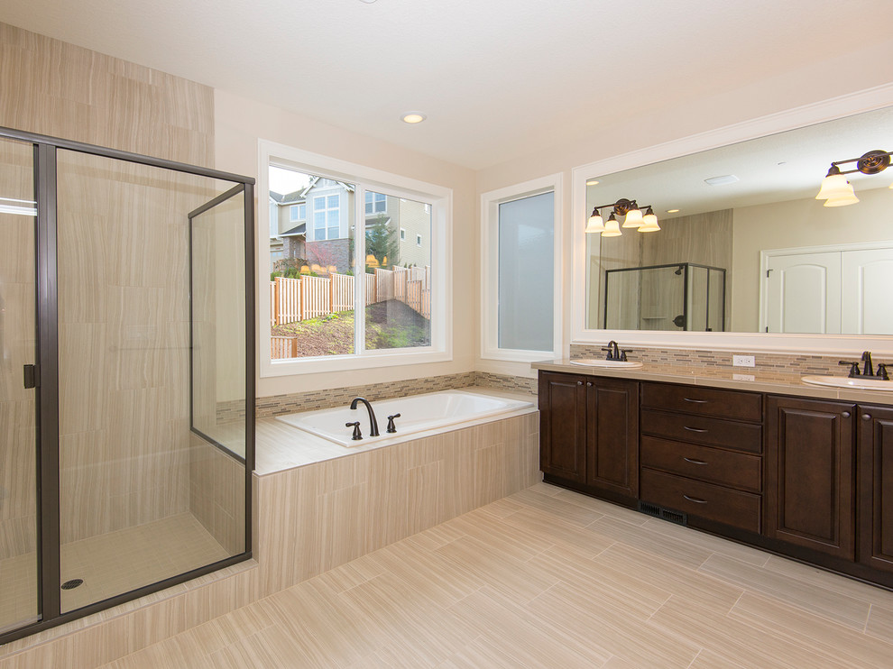 Example of a huge transitional master porcelain tile porcelain tile bathroom design in Portland with a drop-in sink, raised-panel cabinets, dark wood cabinets and tile countertops