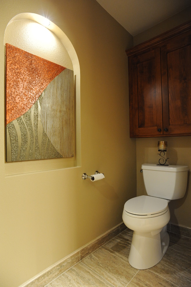 Large classic cloakroom in Milwaukee with shaker cabinets, medium wood cabinets, a two-piece toilet, multi-coloured tiles, porcelain tiles, beige walls and porcelain flooring.
