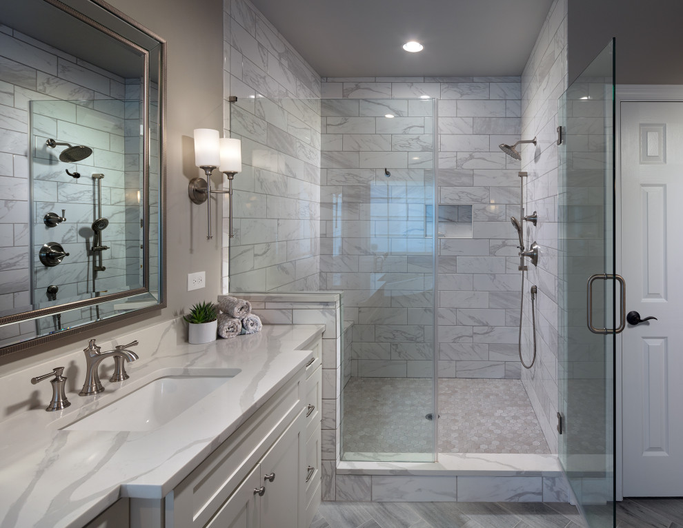 Inspiration for a medium sized modern ensuite bathroom in Atlanta with shaker cabinets, white cabinets, a freestanding bath, a built-in shower, a one-piece toilet, grey tiles, ceramic tiles, grey walls, ceramic flooring, a submerged sink, engineered stone worktops, grey floors, a hinged door, white worktops, a shower bench, a single sink, a built in vanity unit and a coffered ceiling.