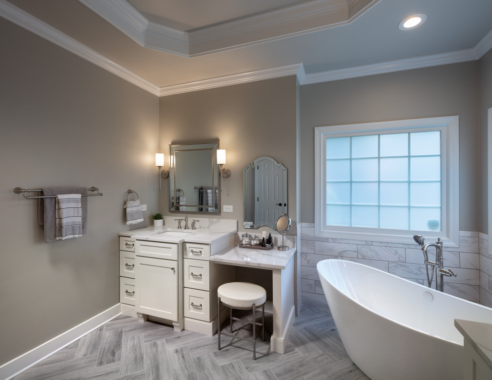 Photo of a medium sized modern ensuite bathroom in Atlanta with shaker cabinets, white cabinets, a freestanding bath, a built-in shower, a one-piece toilet, grey tiles, ceramic tiles, grey walls, ceramic flooring, a submerged sink, engineered stone worktops, grey floors, a hinged door, white worktops, an enclosed toilet, a single sink, a built in vanity unit and a coffered ceiling.
