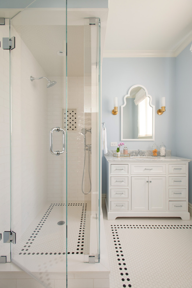 This is an example of a medium sized classic family bathroom in Boston with recessed-panel cabinets, white cabinets, white tiles, metro tiles, blue walls, white floors, a hinged door, grey worktops, a single sink, a freestanding vanity unit, a corner shower, mosaic tile flooring, a submerged sink and a wall niche.