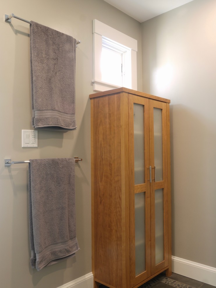 Inspiration for a medium sized traditional ensuite bathroom in Boston with flat-panel cabinets, medium wood cabinets, an alcove shower, a two-piece toilet, white tiles, porcelain tiles, beige walls, porcelain flooring, a submerged sink, engineered stone worktops, grey floors, a hinged door and grey worktops.