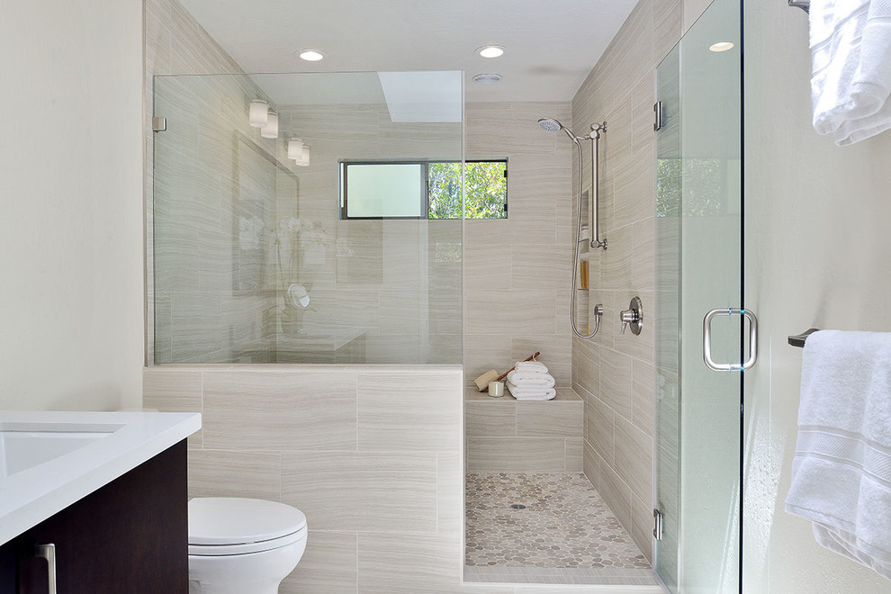 Design ideas for a medium sized ensuite wet room bathroom in San Francisco with shaker cabinets, black cabinets, an alcove bath, a two-piece toilet, beige tiles, porcelain tiles, beige walls, porcelain flooring, a submerged sink, engineered stone worktops, beige floors and a hinged door.