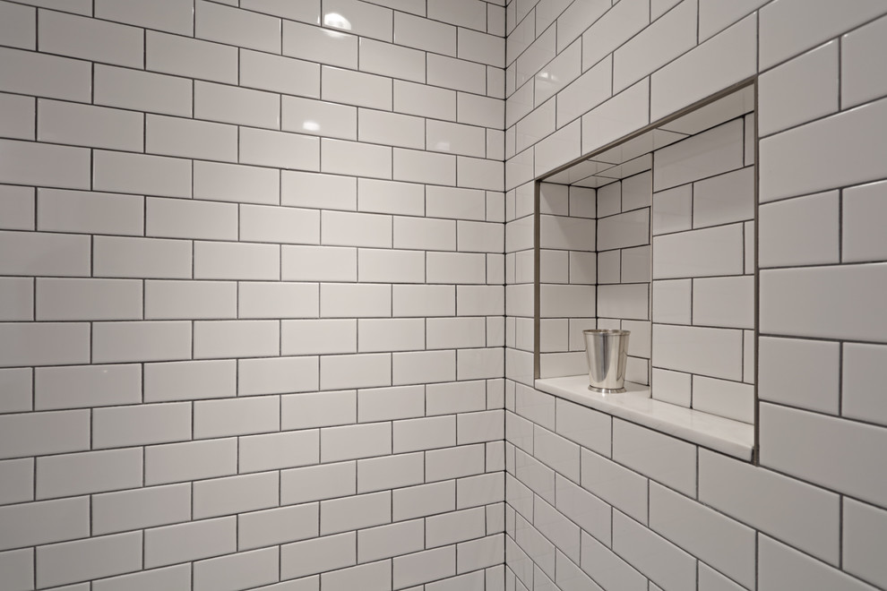 Photo of a small modern shower room bathroom in New York with a corner shower, a one-piece toilet, white tiles, porcelain tiles, white walls, ceramic flooring, a pedestal sink and grey floors.