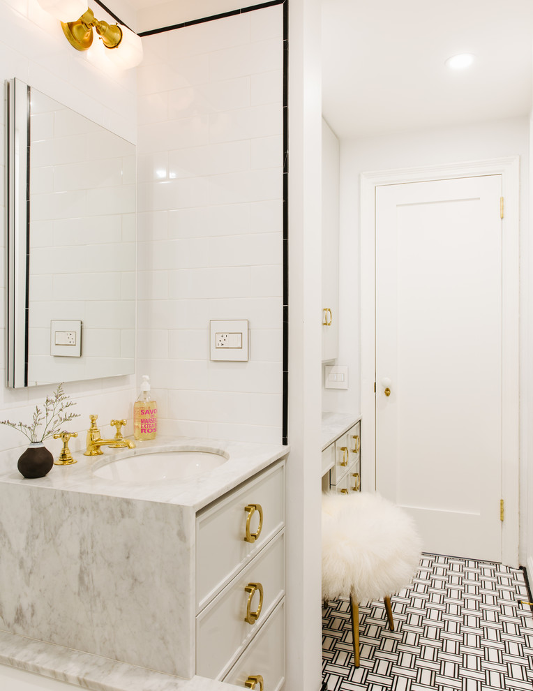 Example of a mid-sized danish 3/4 white tile and ceramic tile ceramic tile and black floor bathroom design in Tampa with recessed-panel cabinets, white cabinets, an undermount tub, marble countertops, a one-piece toilet, white walls and an undermount sink