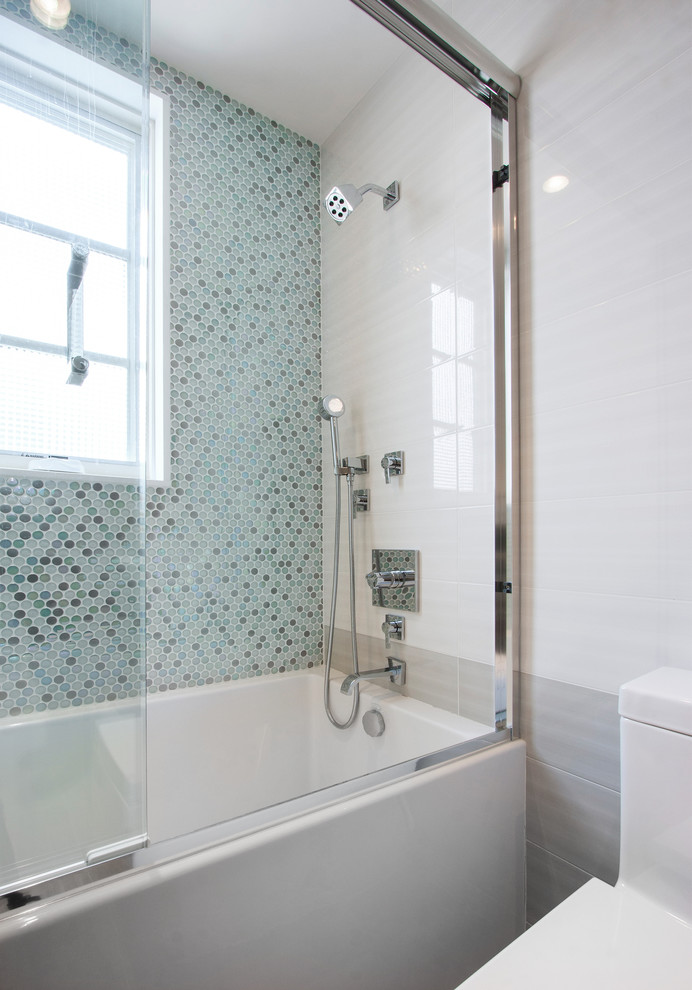 Diseño de cuarto de baño actual con bañera encastrada, sanitario de una pieza y baldosas y/o azulejos azules
