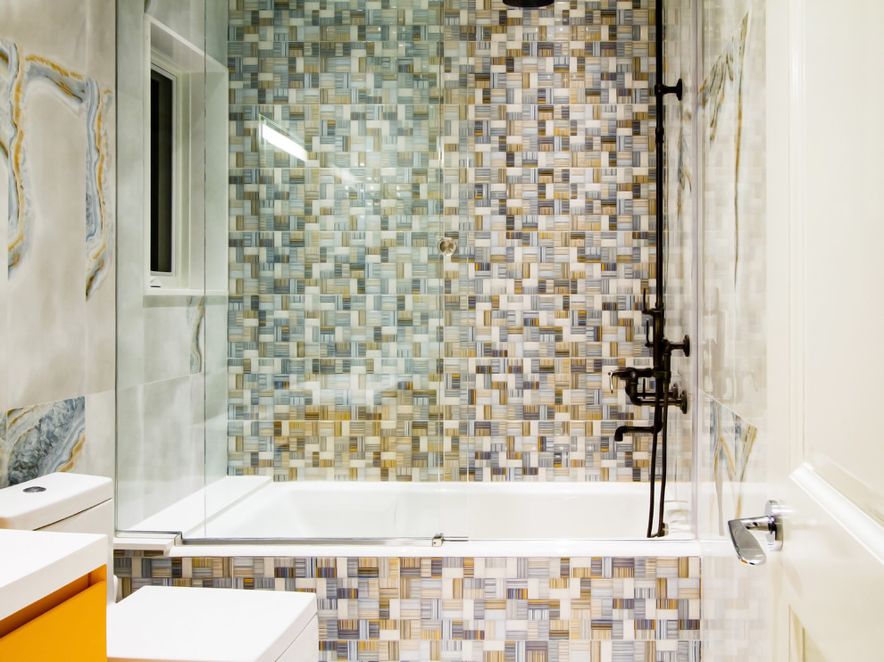 Medium sized contemporary bathroom in New York with yellow cabinets, a built-in bath, a shower/bath combination, a sliding door, flat-panel cabinets, a one-piece toilet and an integrated sink.