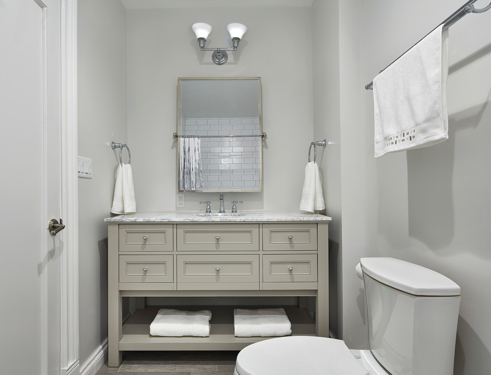 Mid-sized transitional 3/4 white tile and subway tile medium tone wood floor and brown floor bathroom photo in New York with gray walls, furniture-like cabinets, beige cabinets, an undermount sink and marble countertops