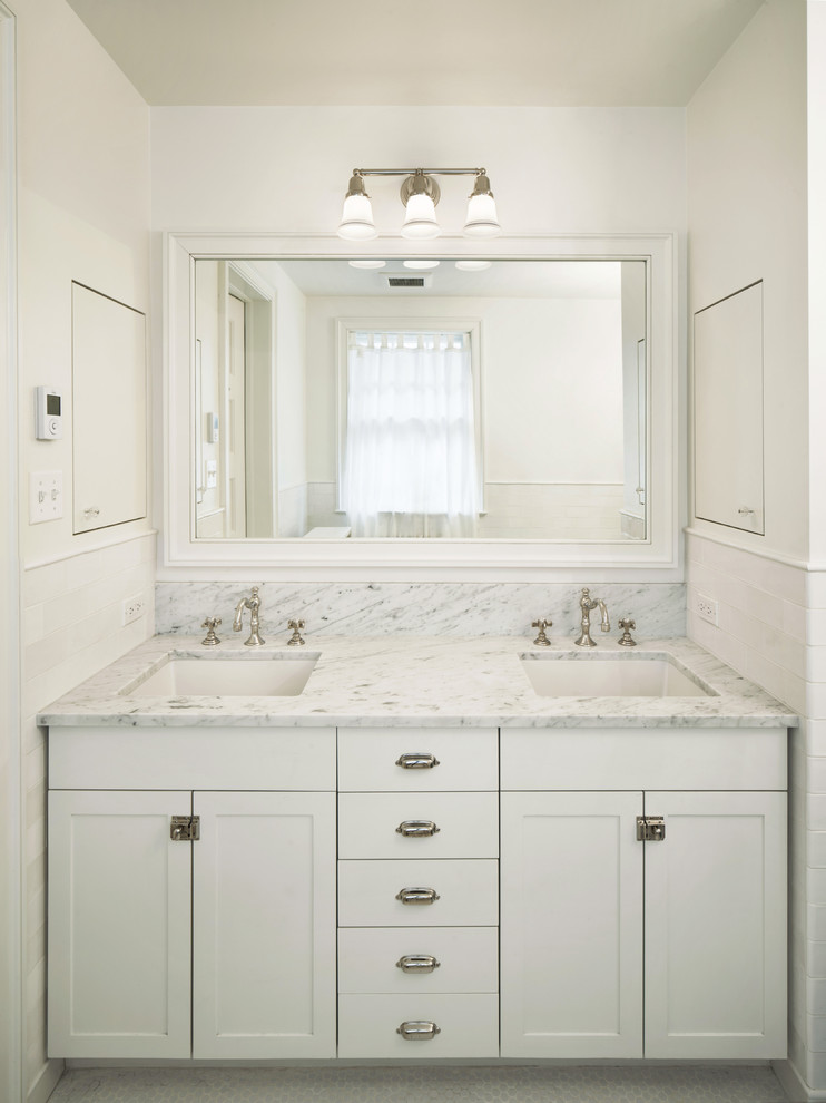This is an example of a medium sized romantic ensuite bathroom in New York with a built-in sink, shaker cabinets, white cabinets, marble worktops, a claw-foot bath, a one-piece toilet, white tiles, metro tiles, white walls and mosaic tile flooring.