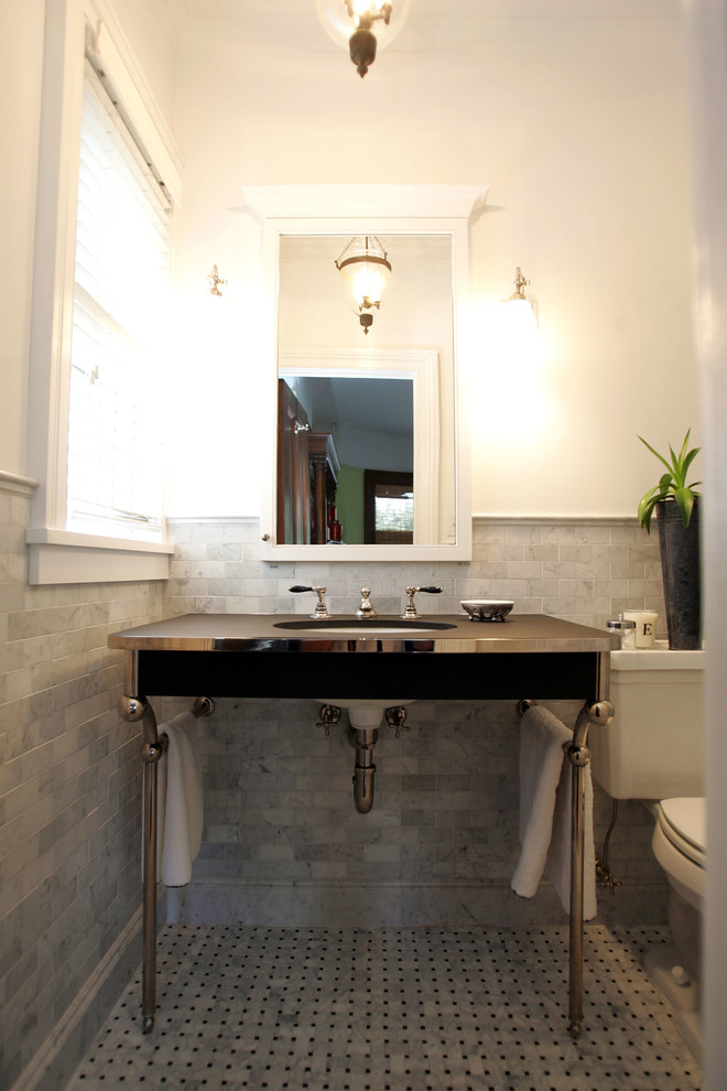 Inredning av ett klassiskt mellanstort en-suite badrum, med ett undermonterad handfat, öppna hyllor, grå skåp, granitbänkskiva, en dusch i en alkov, en toalettstol med separat cisternkåpa, grå kakel, stenkakel, grå väggar och mosaikgolv