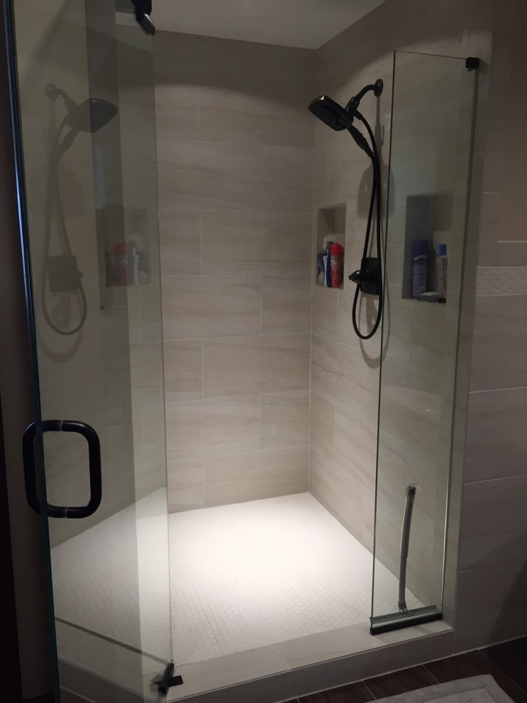 Example of a large classic master beige tile and porcelain tile porcelain tile bathroom design in Columbus with raised-panel cabinets, dark wood cabinets, a two-piece toilet, yellow walls, an undermount sink and granite countertops