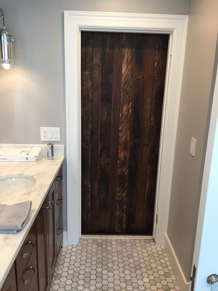 This is an example of a medium sized contemporary ensuite bathroom in Kansas City with shaker cabinets, white tiles, dark wood cabinets, a built-in bath, grey walls, porcelain flooring, a submerged sink, a shower/bath combination, metro tiles, quartz worktops, grey floors, a shower curtain and white worktops.