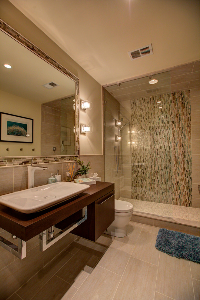 Example of a small trendy master beige tile walk-in shower design in Other with a vessel sink, open cabinets, dark wood cabinets, a one-piece toilet and beige walls
