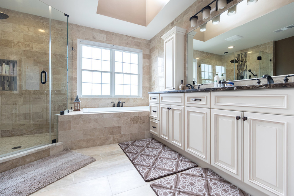 Example of a mid-sized classic master beige tile and ceramic tile ceramic tile doorless shower design in DC Metro with raised-panel cabinets, beige cabinets, a hot tub, a one-piece toilet, brown walls, an undermount sink and granite countertops