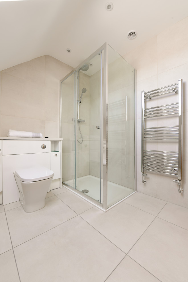 Photo of a contemporary bathroom in London with beige tiles, porcelain tiles, porcelain flooring and beige floors.