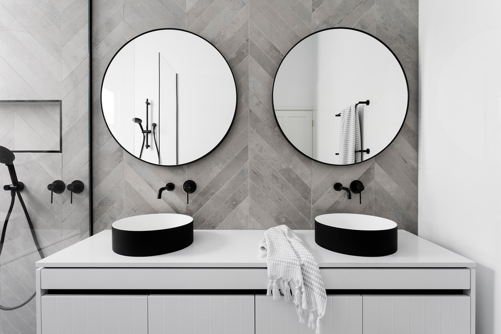 Example of a mid-sized trendy master white tile and cement tile bathroom design in Melbourne with flat-panel cabinets, white cabinets, a wall-mount toilet, a vessel sink and quartz countertops