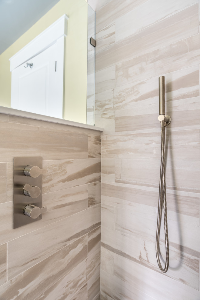 Inspiration for a large contemporary master multicolored tile and porcelain tile porcelain tile and gray floor bathroom remodel in New York with recessed-panel cabinets, medium tone wood cabinets, a one-piece toilet, yellow walls, an undermount sink, quartzite countertops and a hinged shower door