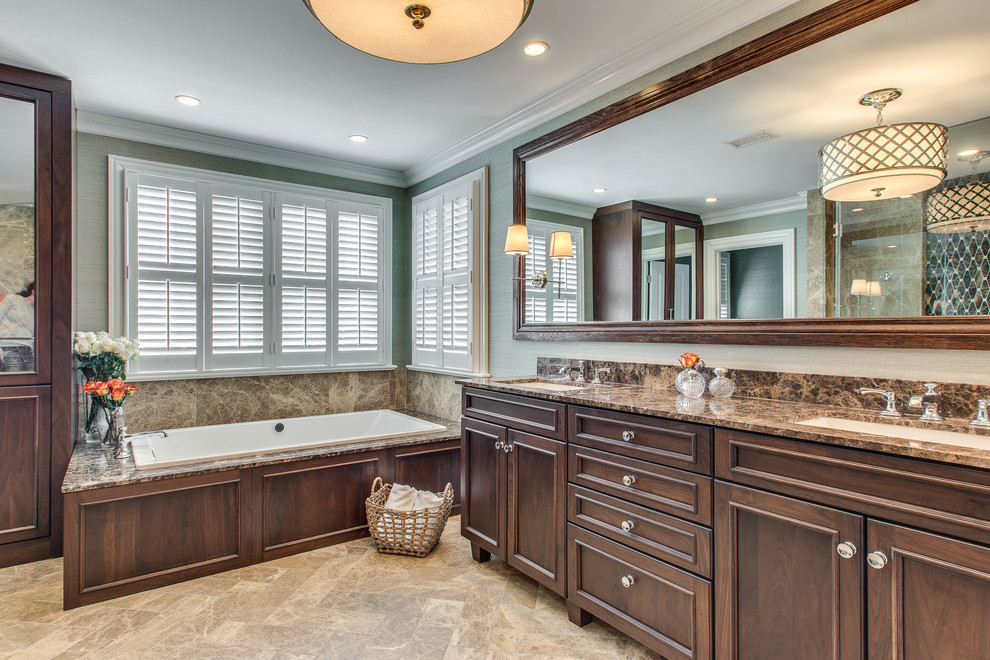 На фото: большая главная ванная комната в классическом стиле с врезной раковиной, темными деревянными фасадами, накладной ванной, двойным душем, раздельным унитазом, синими стенами, мраморным полом и мраморной столешницей