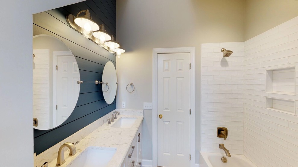 Example of a small transitional kids' white tile and porcelain tile porcelain tile and brown floor bathroom design in Raleigh with shaker cabinets, white cabinets, a two-piece toilet, gray walls, an undermount sink, quartz countertops and white countertops