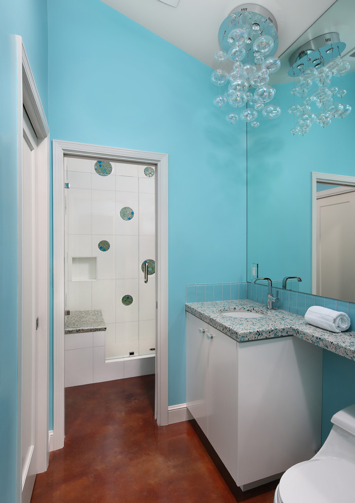 Immagine di una stanza da bagno contemporanea con lavabo sottopiano, ante lisce, ante bianche, top in vetro riciclato, piastrelle blu e piastrelle di vetro