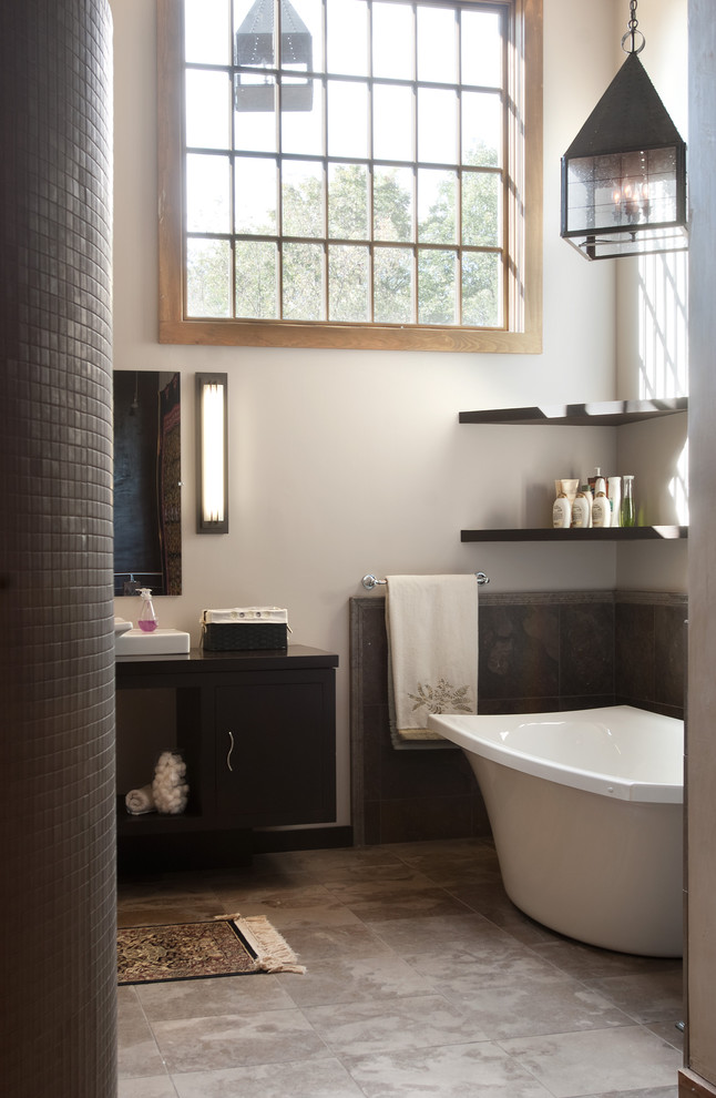 Inspiration for a mid-sized timeless 3/4 mosaic tile and gray tile porcelain tile freestanding bathtub remodel in Philadelphia with flat-panel cabinets, dark wood cabinets, a two-piece toilet, gray walls, a vessel sink and quartz countertops