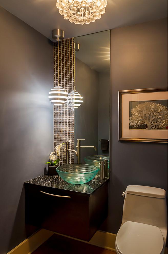 Photo of a medium sized contemporary cloakroom in Chicago with flat-panel cabinets, black cabinets, blue tiles, glass tiles, granite worktops, a one-piece toilet, blue walls, medium hardwood flooring and a vessel sink.