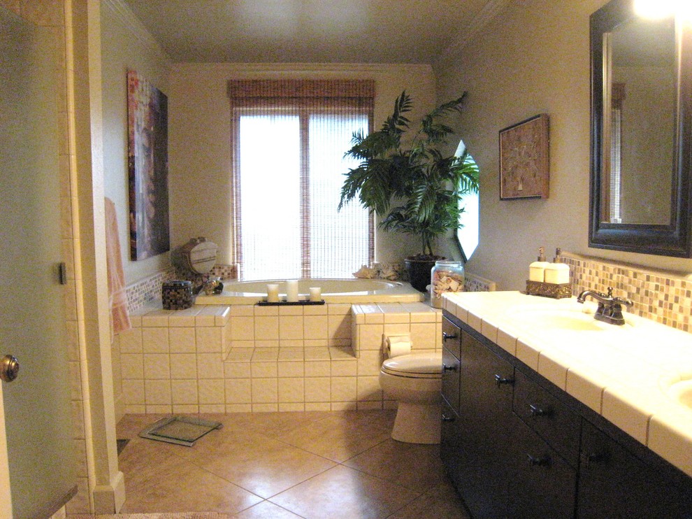 Idéer för mellanstora vintage badrum, med ett undermonterad handfat, släta luckor, skåp i mörkt trä, kaklad bänkskiva, ett platsbyggt badkar, en dusch i en alkov, en toalettstol med hel cisternkåpa, beige kakel, keramikplattor, beige väggar och klinkergolv i porslin
