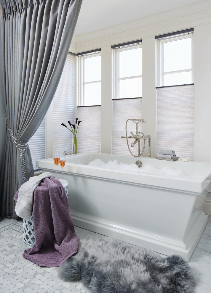 Photo of a medium sized classic ensuite bathroom in Bridgeport with a freestanding bath, grey walls, ceramic flooring and grey floors.