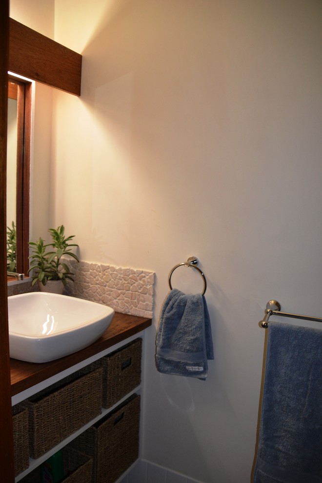 Photo of a small contemporary bathroom in Sydney with a vessel sink, open cabinets, white cabinets, wooden worktops, white tiles, white walls, ceramic flooring and an alcove shower.