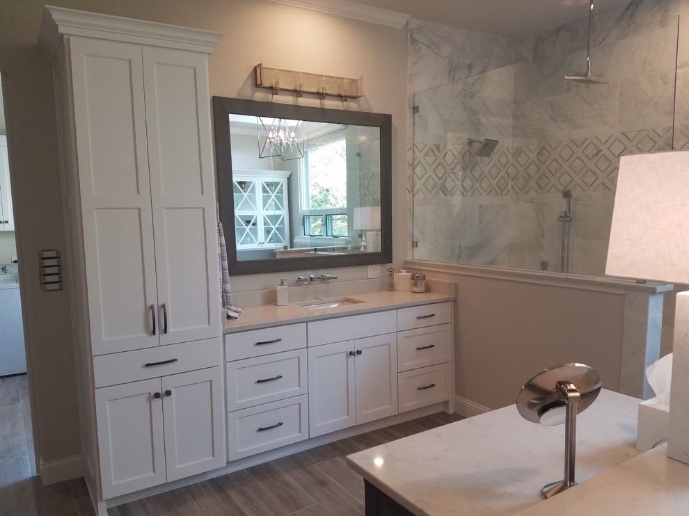 Large classic ensuite bathroom in Dallas with recessed-panel cabinets, white cabinets, a submerged bath, a walk-in shower, a two-piece toilet, white tiles, marble tiles, beige walls, ceramic flooring, a submerged sink, engineered stone worktops and an open shower.